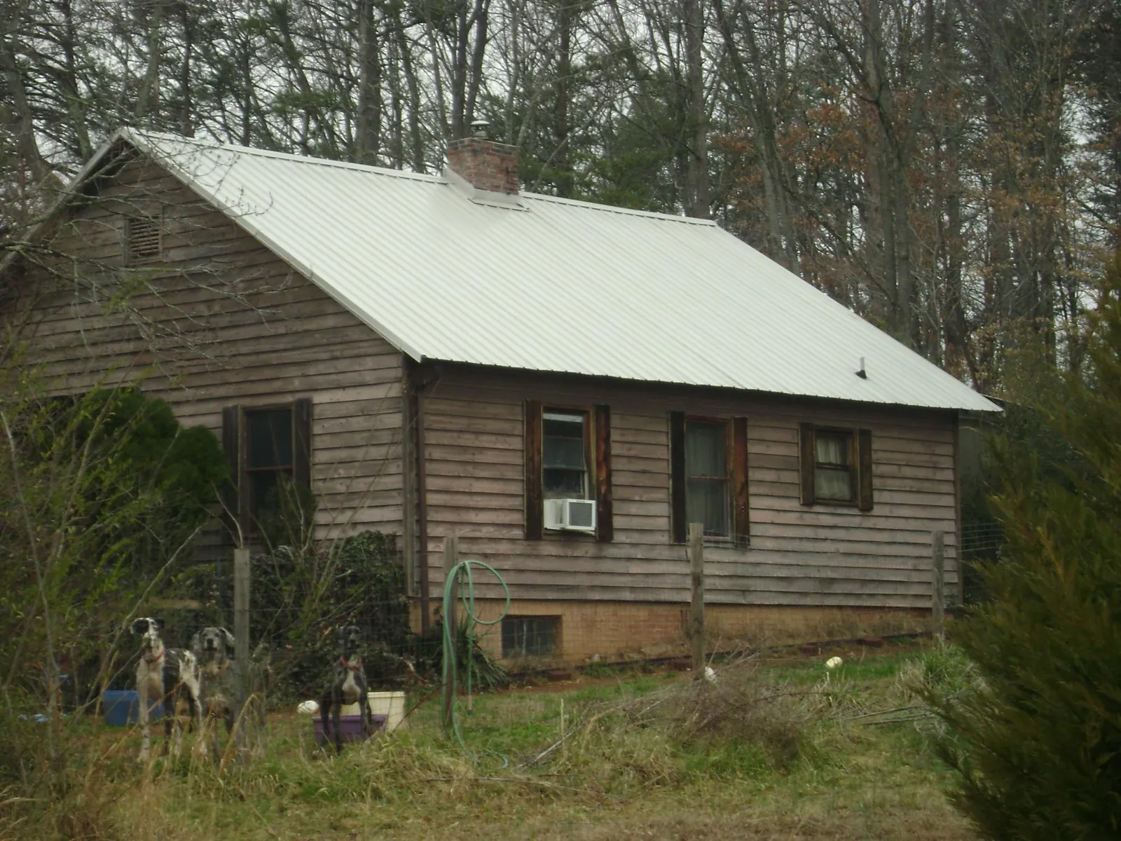 White metal roof on an old wood sided farmhouse, from a Metal Roof Installation job in East Springfield